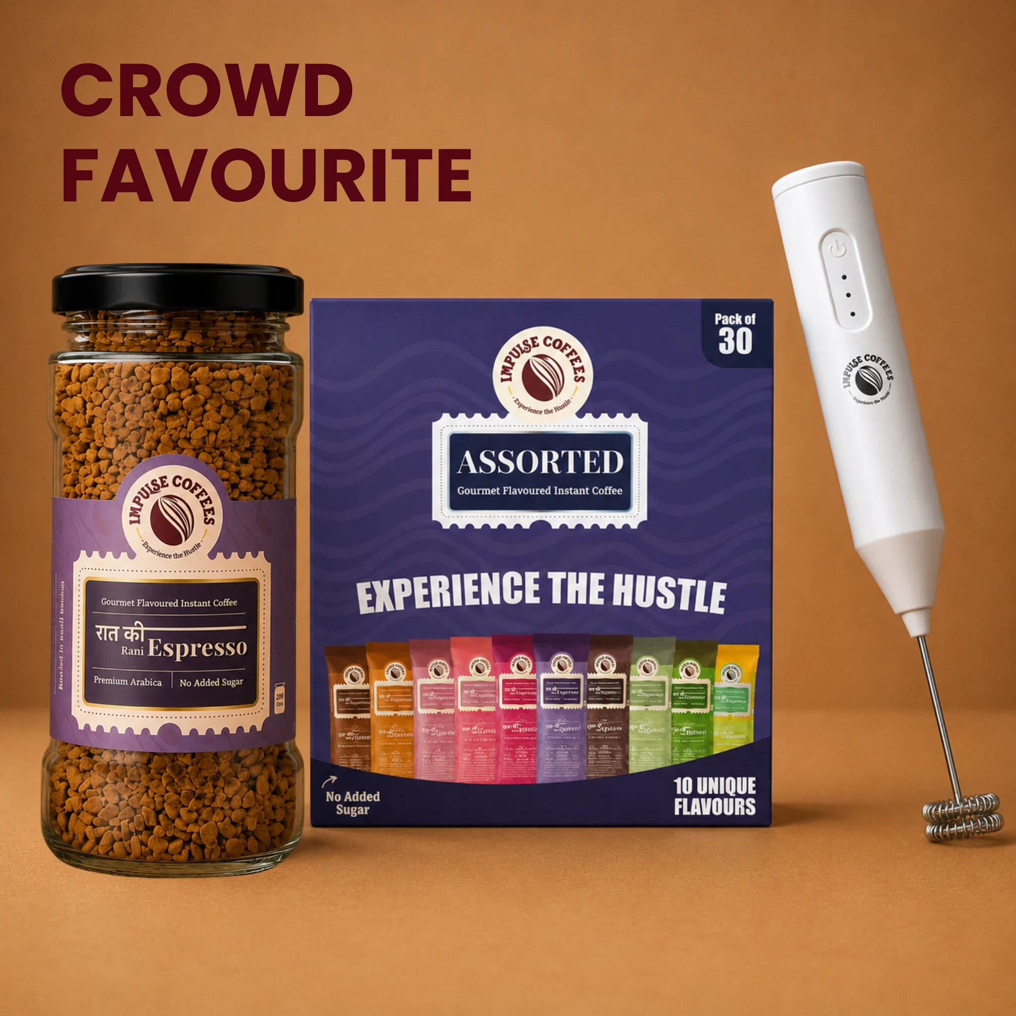 Impulse Coffees Pre-Workout Combo featuring a premium glass jar of Raat Ki Rani Espresso premium Arabica instant coffee, a box of 30 assorted gourmet coffee sachets with 10 unique flavours, and a white electric coffee frother wand on a solid brown backdrop.