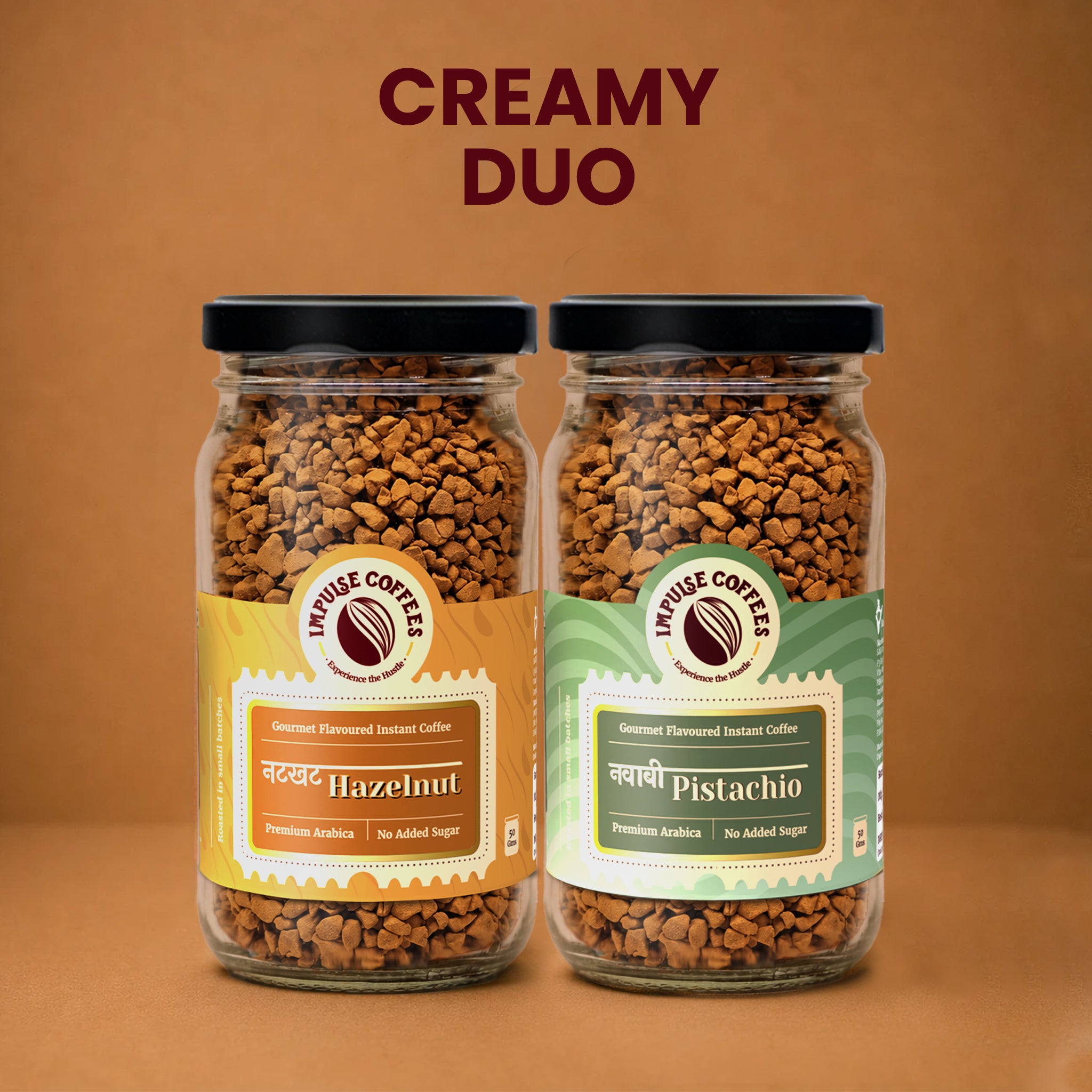 Impulse Coffees Nutcase Combo premium product bundle featuring a twin set of glass jars standing side-by-side on a warm brown background: Nutkhat Hazelnut and Nawabi Pistachio gourmet flavoured instant coffee.