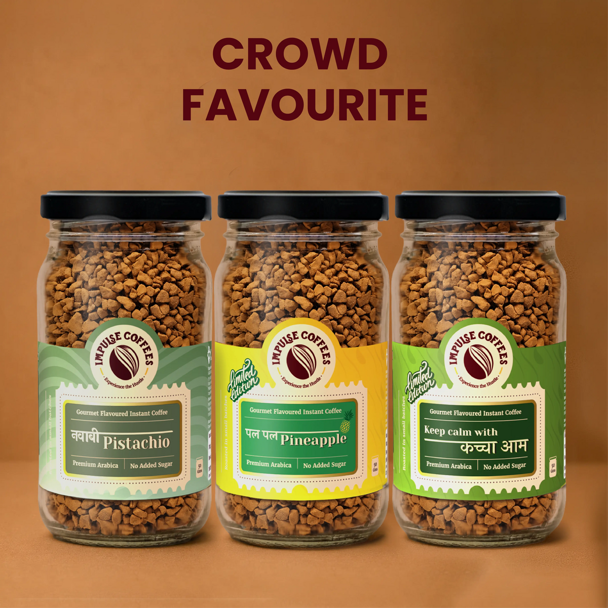 Three 50g glass jars of Impulse Coffees Gourmet Flavoured Instant Coffee under a Crowd Favourite banner, featuring Nawabi Pistachio, Pal Pal Pineapple, and Keep Calm With Kacha Aam premium Arabica no added sugar coffee variants.