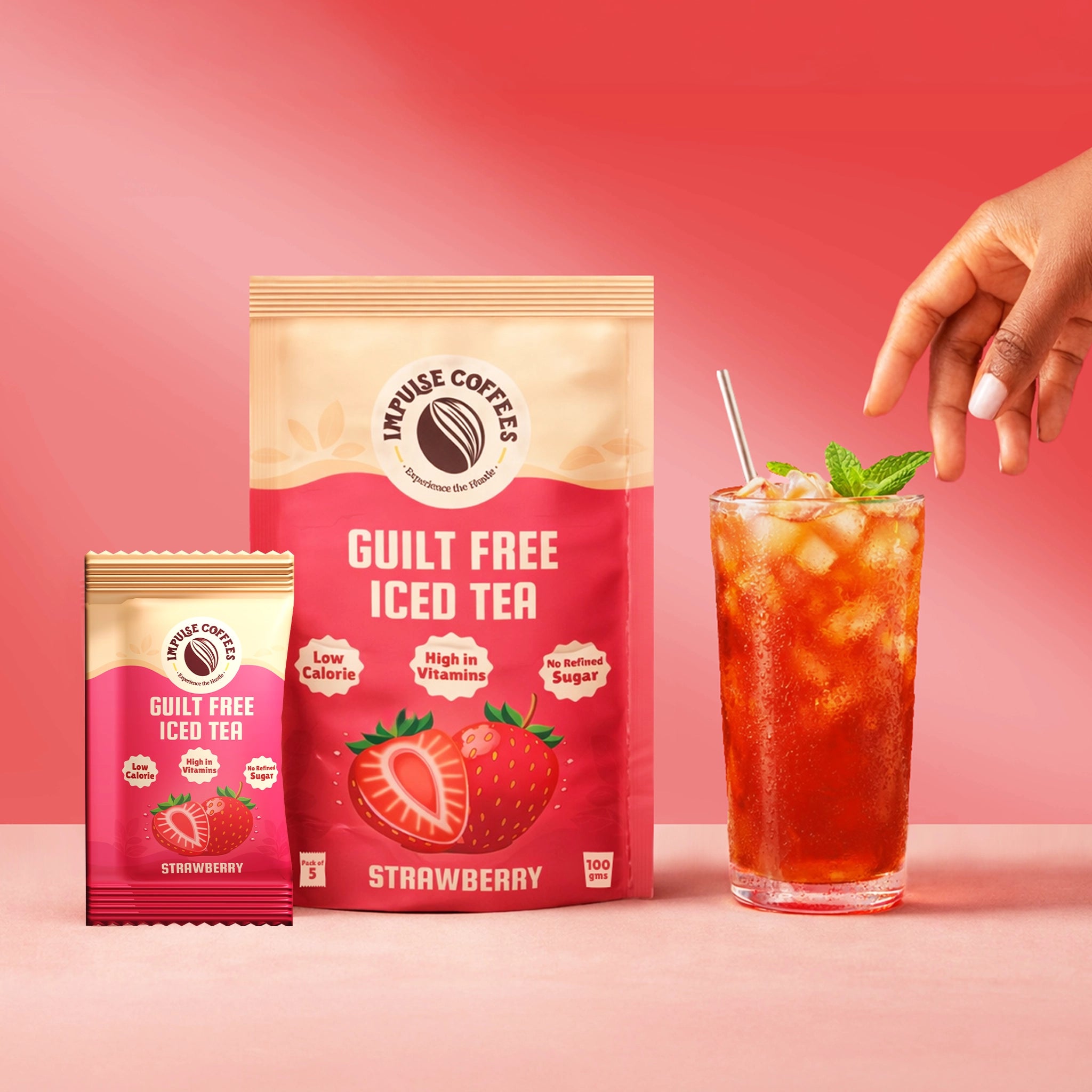 Premium commercial product graphic for Impulse Coffees Guilt Free Strawberry Iced Tea pouch and single-serve sachet next to a tall glass of fresh iced tea topped with mint leaves.